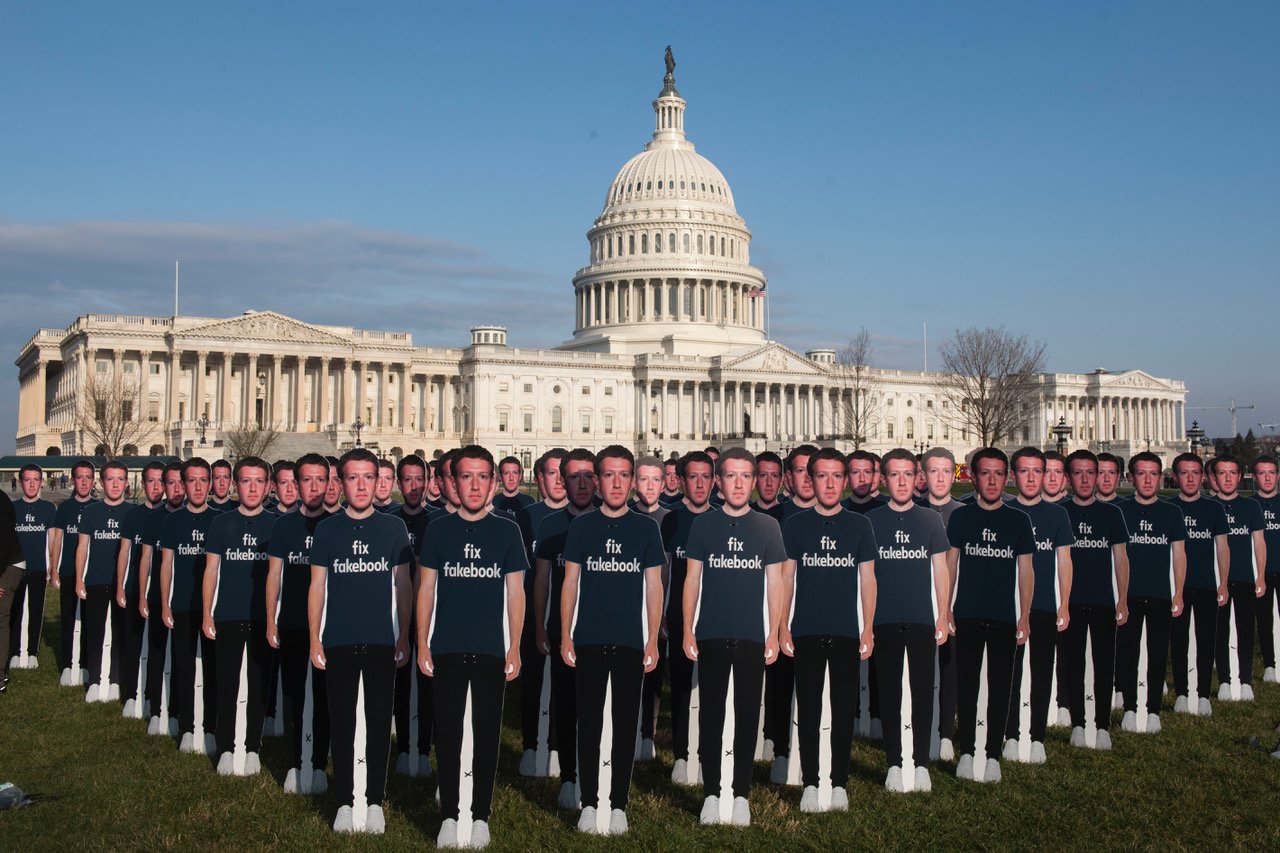 Mark Zuckerberg cut-outs with shirts that say "Fix Fakebook" in front of Capitol Hill