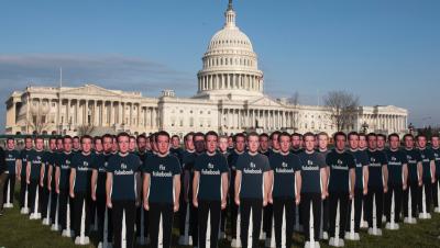 Mark Zuckerberg cut-outs with shirts that say "Fix Fakebook" in front of Capitol Hill