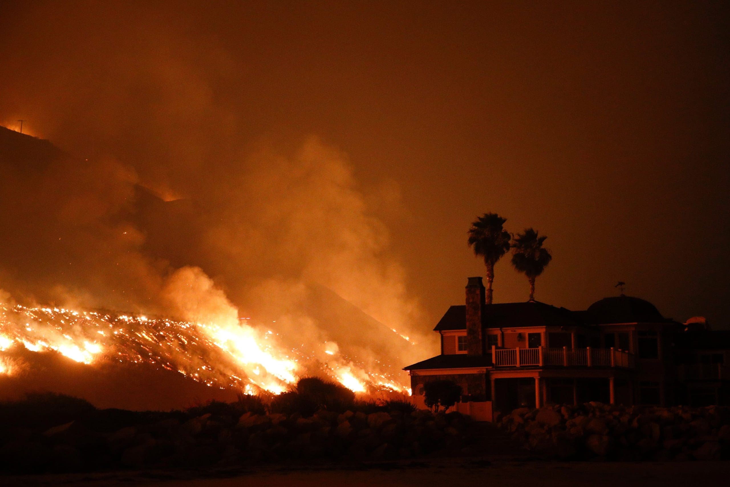 Hillside burns next to home