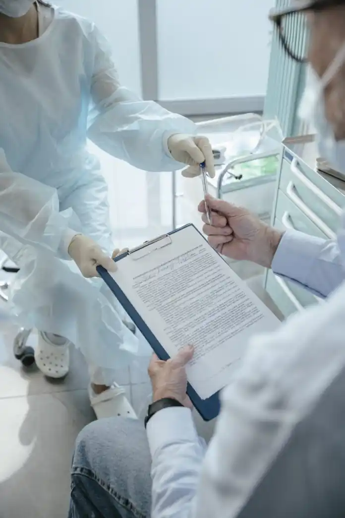 a doctor having a patient sign a document